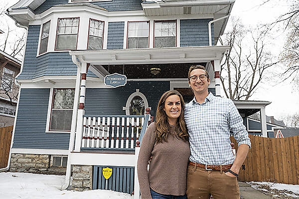 couple outside historic home