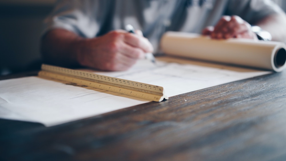 architect drafting blueprint